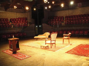 Living room scene set up in the middle of a cow arena