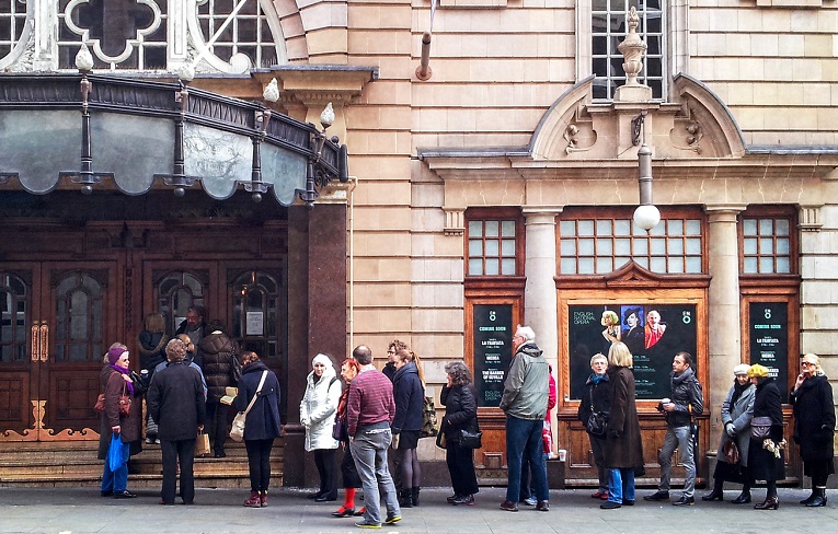 Photo of people queuing outside the London Coliseum