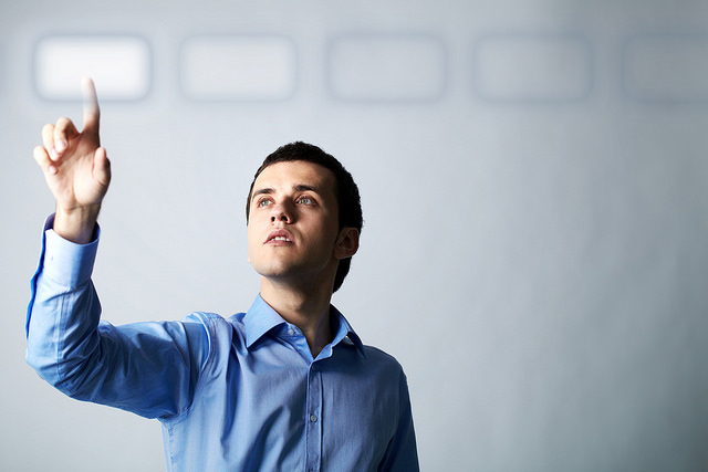 Photo of man pointing at digital button