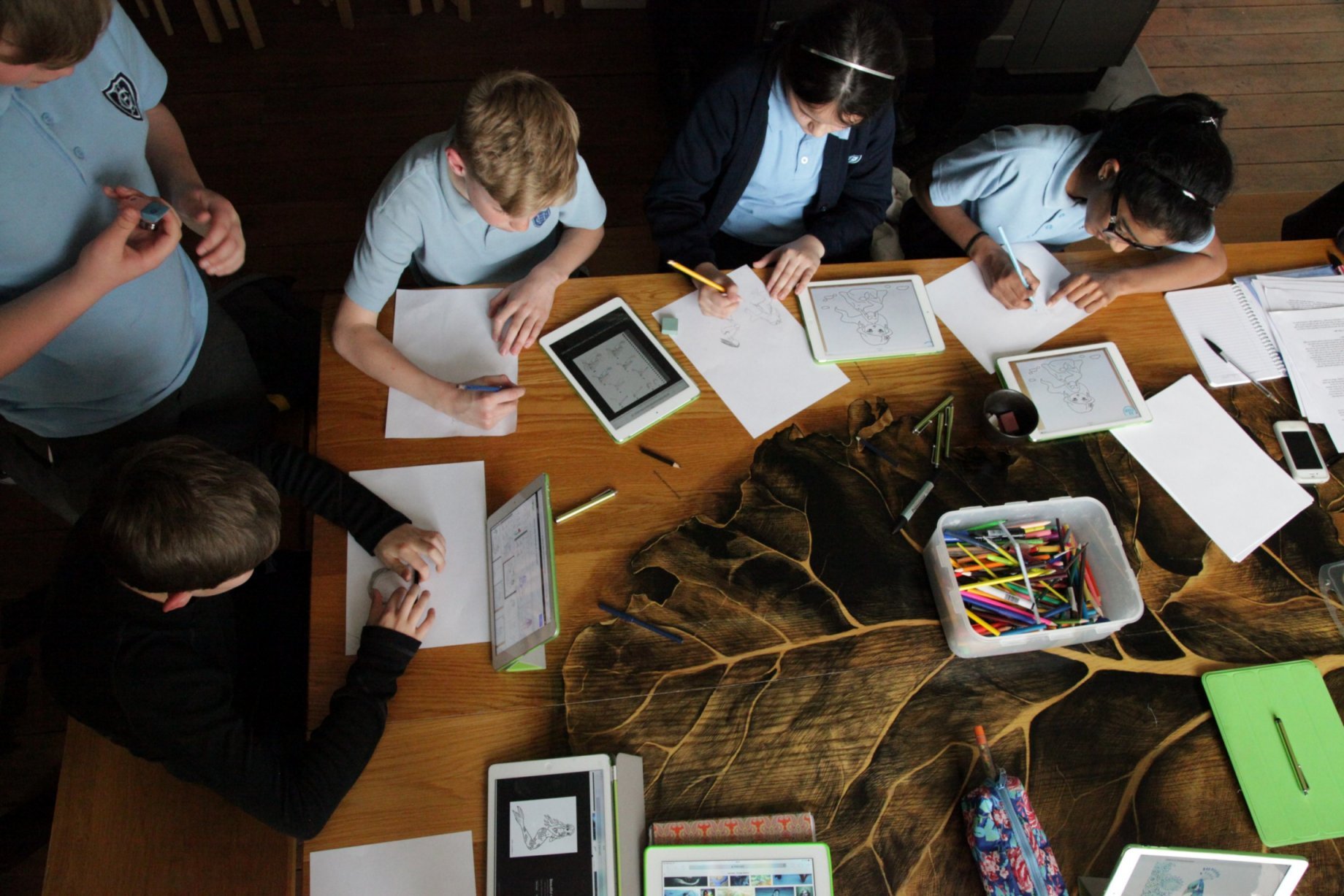 Photo of children drawing with tablets