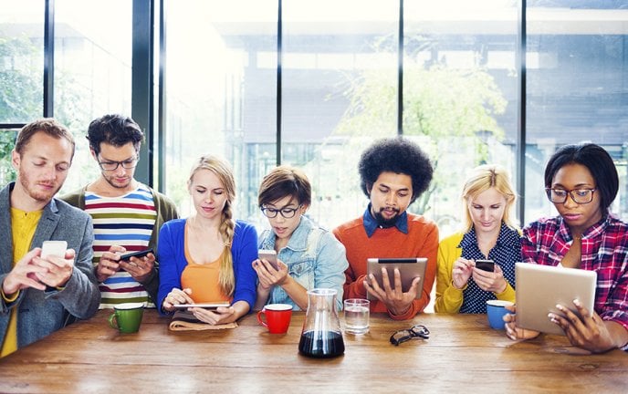 Group of young people with mobiles/tablets