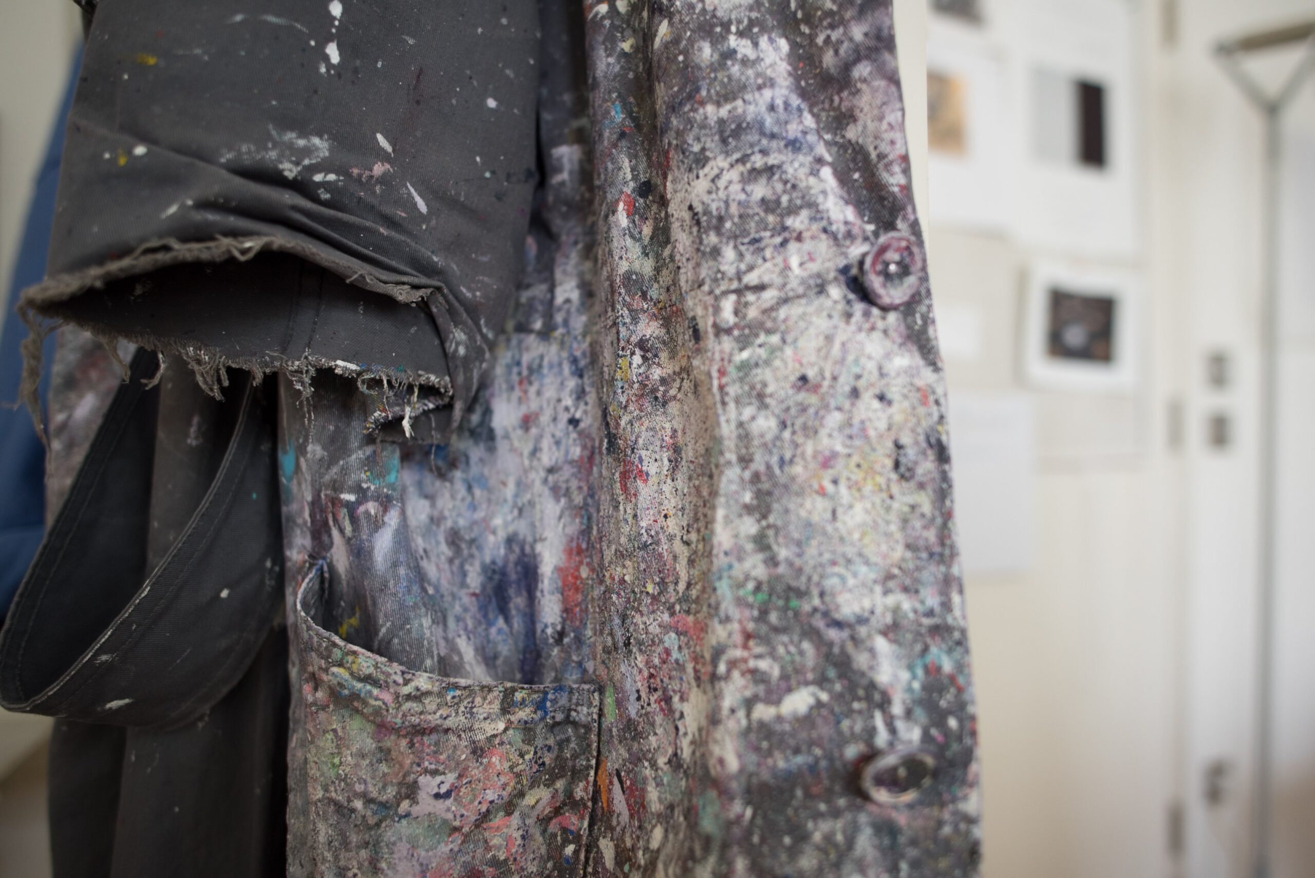 Photo of paint covered coat in artist studio