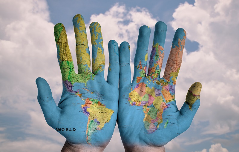 Photo of hands with world map on