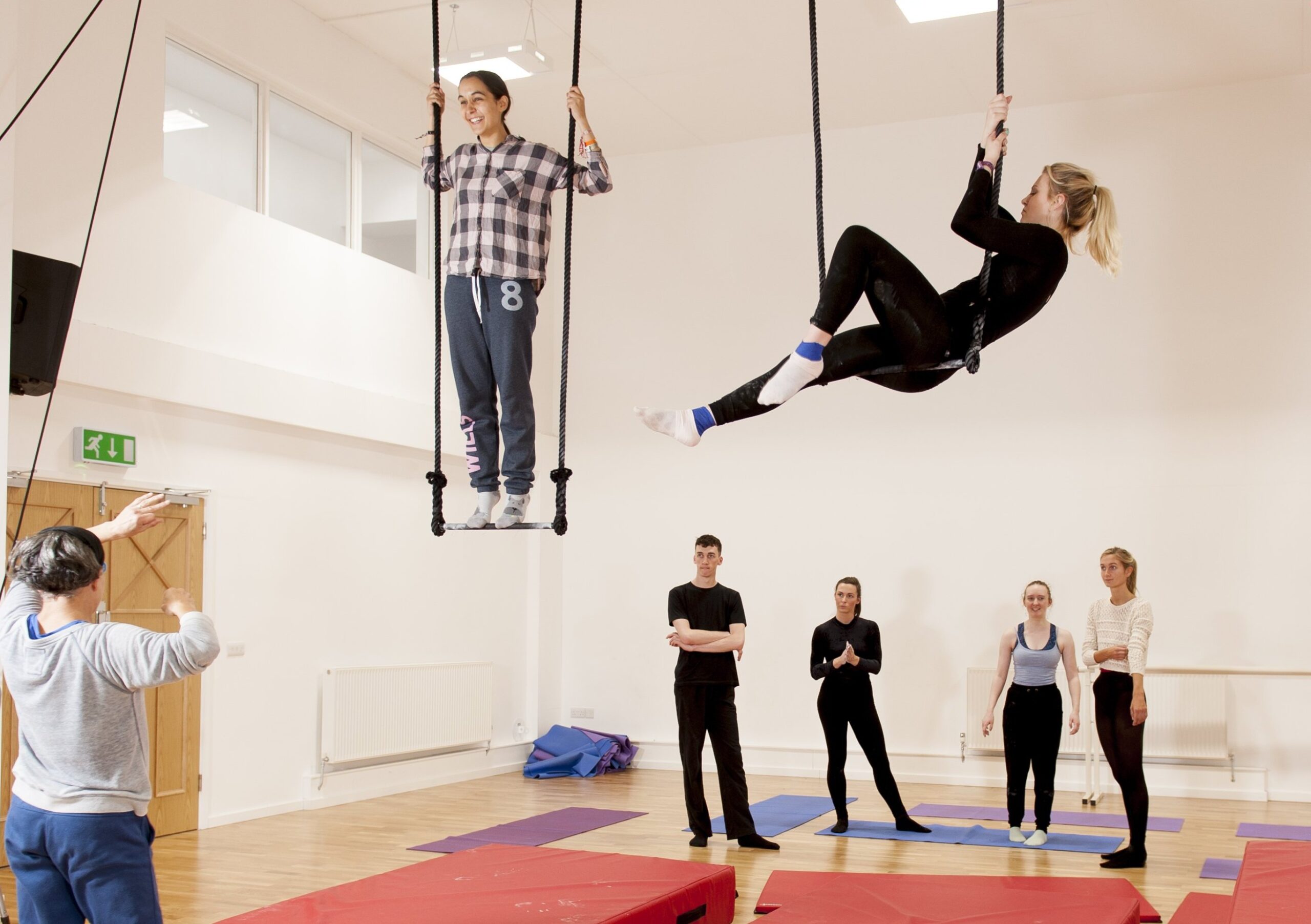 Photo of two aerial dancers, teacher and students