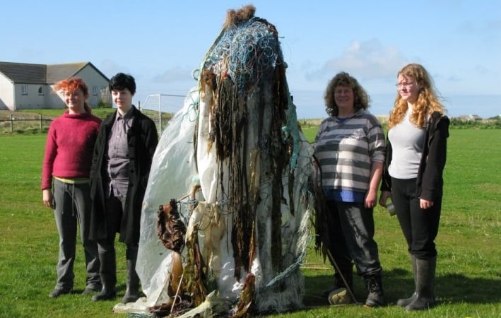 Image of person dressed up as monster withe three others