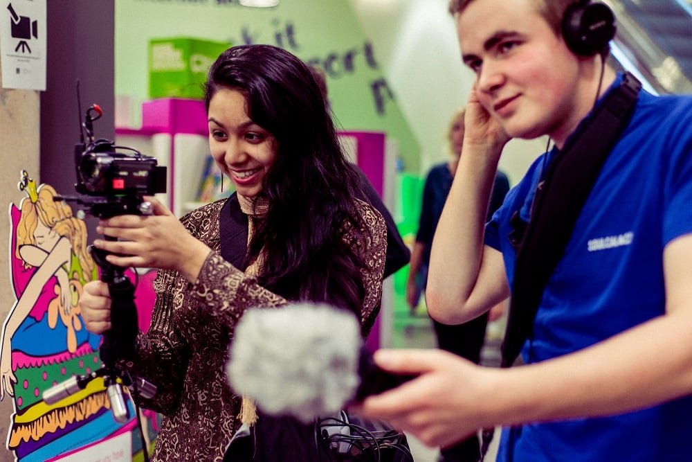 Photo of two young people filming