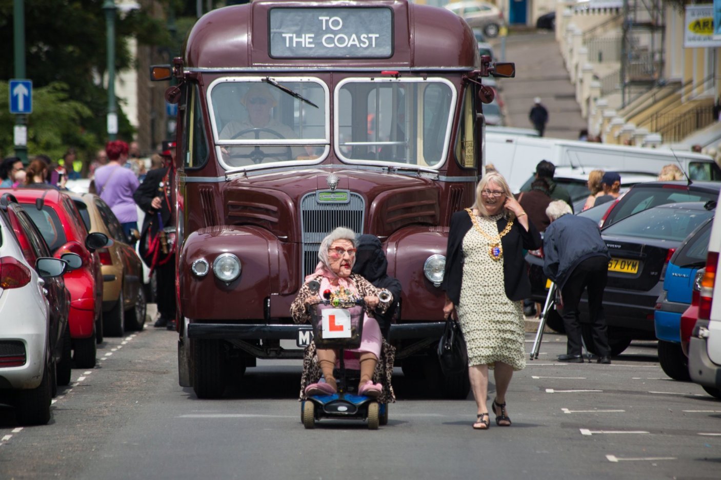 Photo of old bus, scooter and mayor on parade