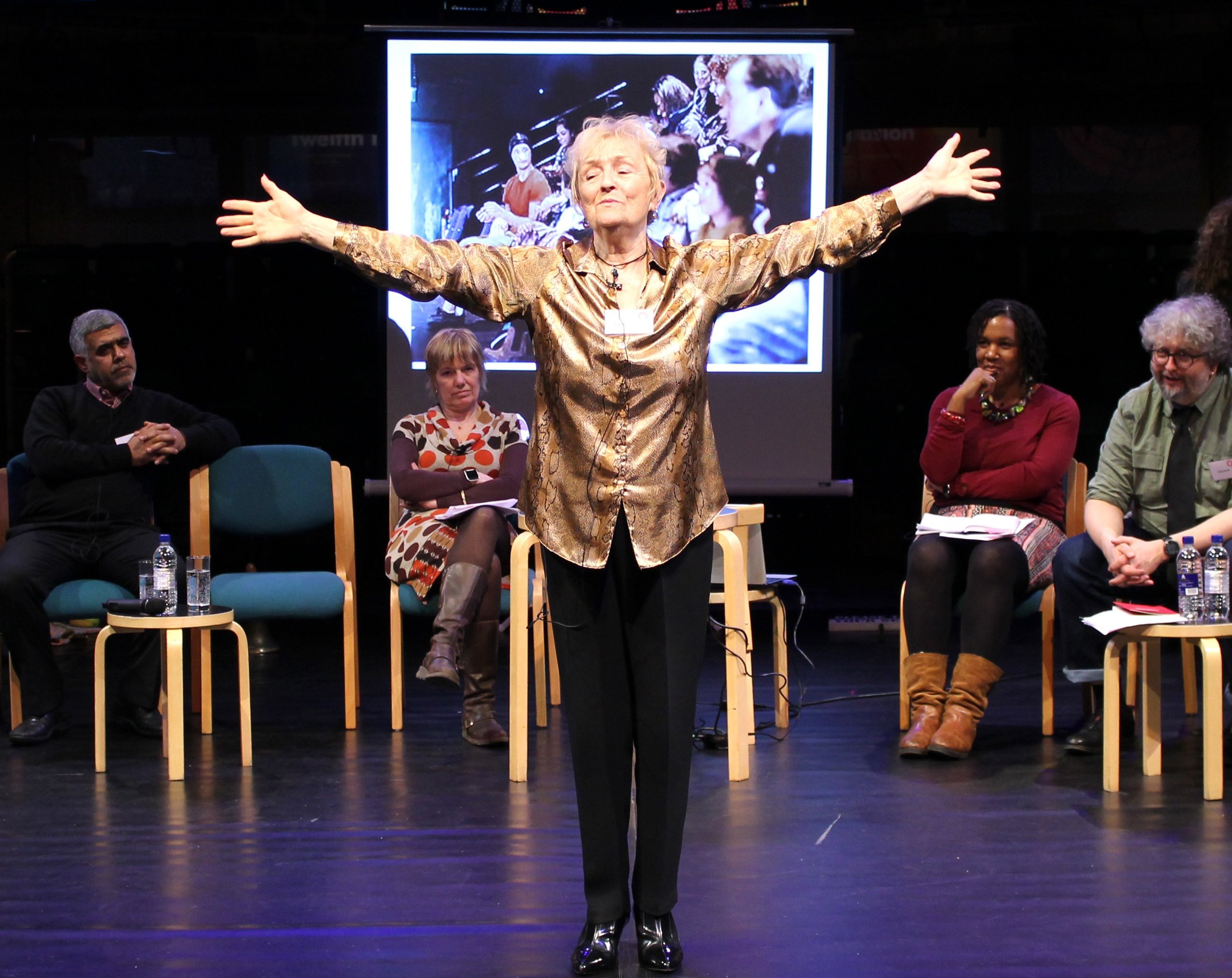 Photo of woman standing with arms out wide