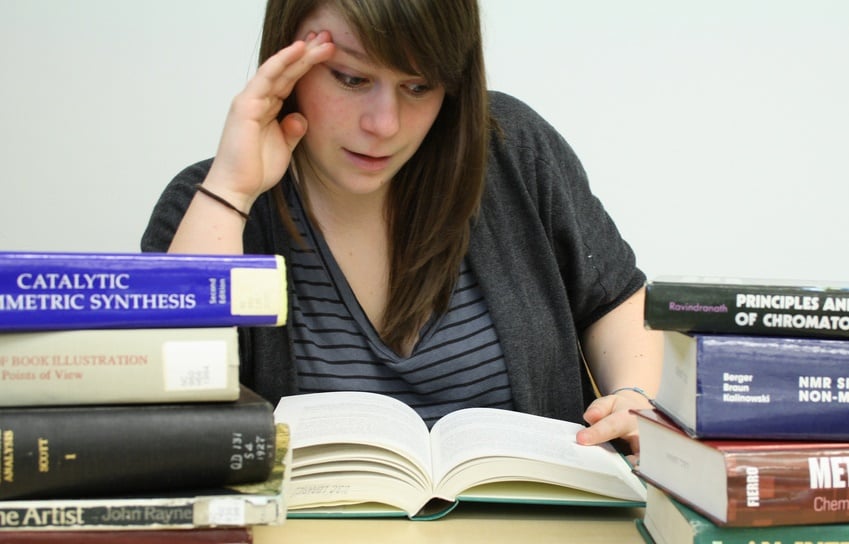 Photo of girl studying with books