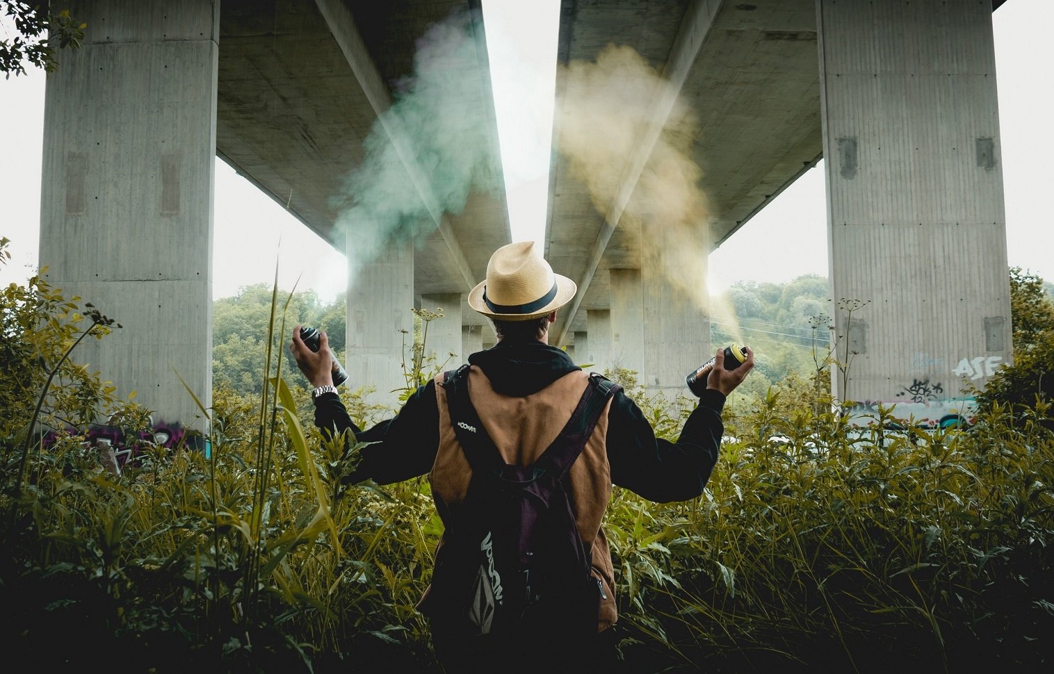 Man spraying aerosols in park