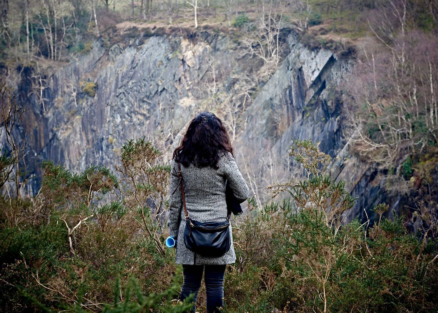 Photo of woman in landscape of rock and trees