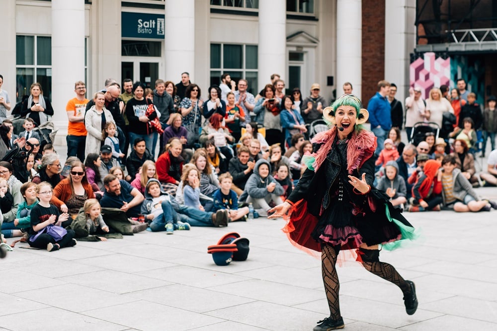 A woman performing in an outdoor square