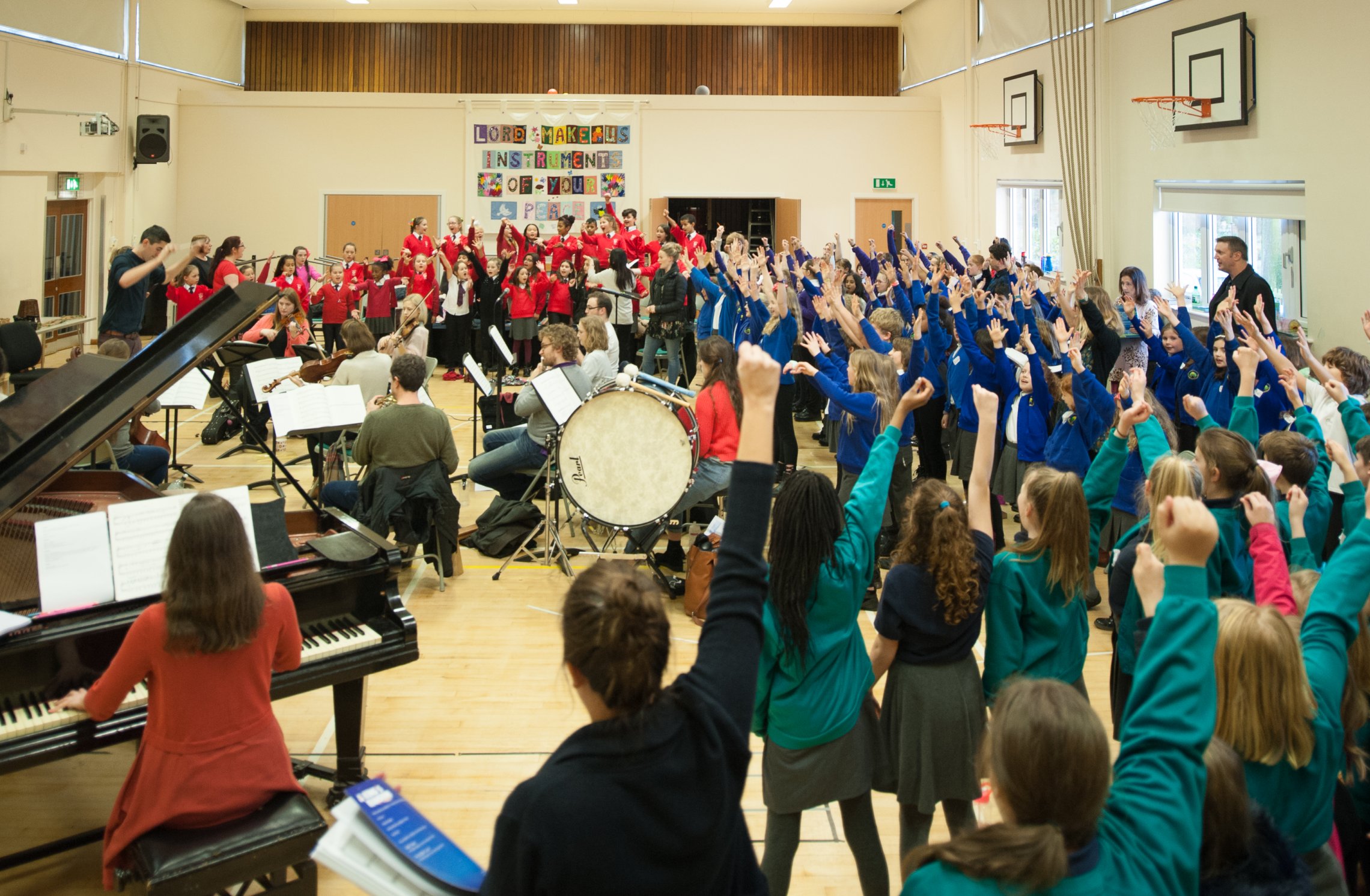 Photo of rehearsal room with singers and musicians