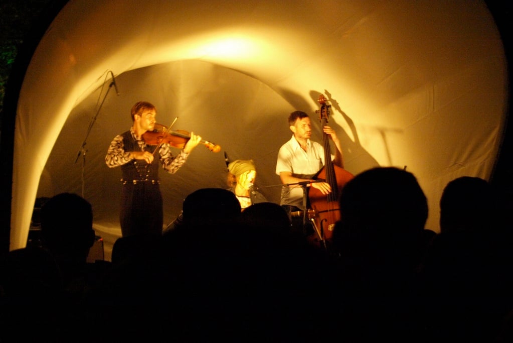 Musicians on stage in front of a crowd