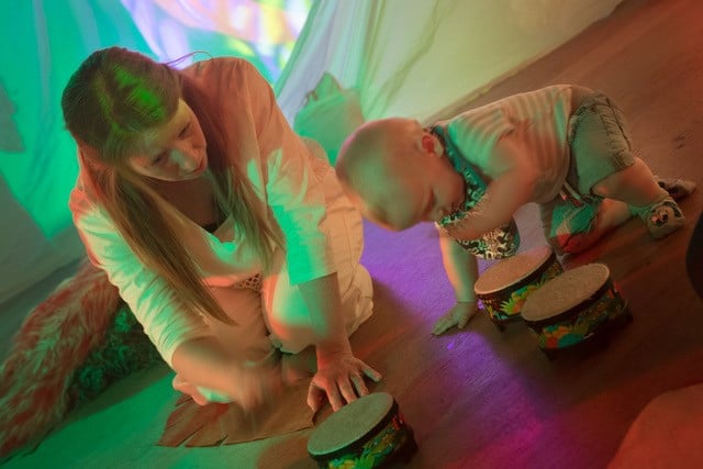 Photo of woman and children drumming