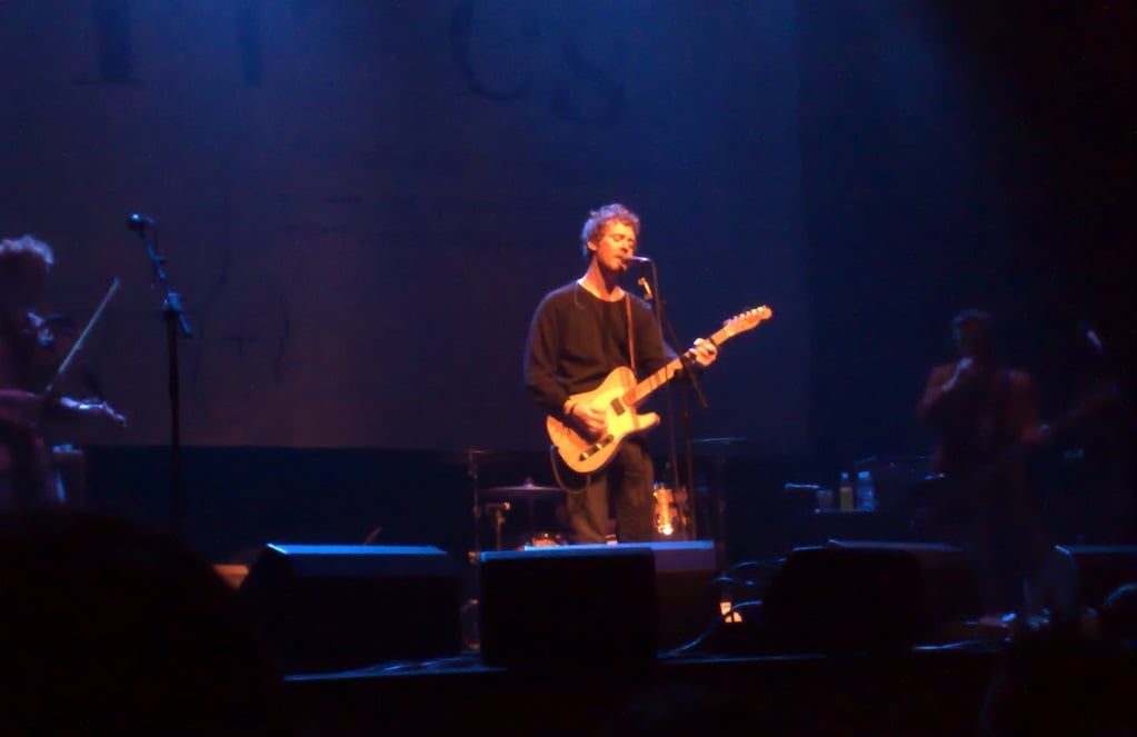 A man playing a guitar on stage