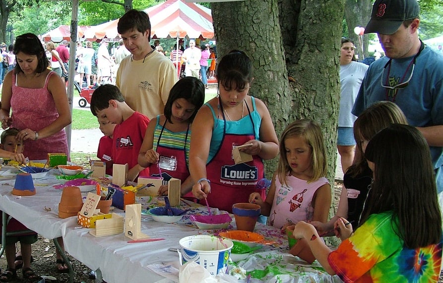 Children painting at an outdoor table