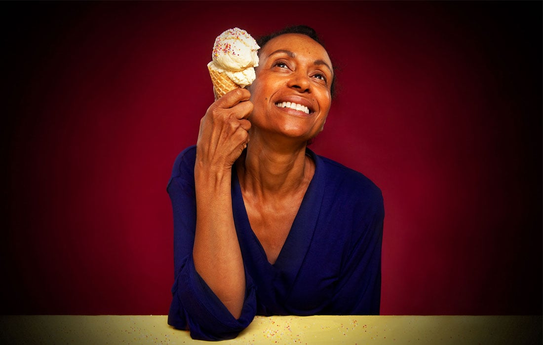 Photo of a woman holding an ice cream staring towards the ceiling