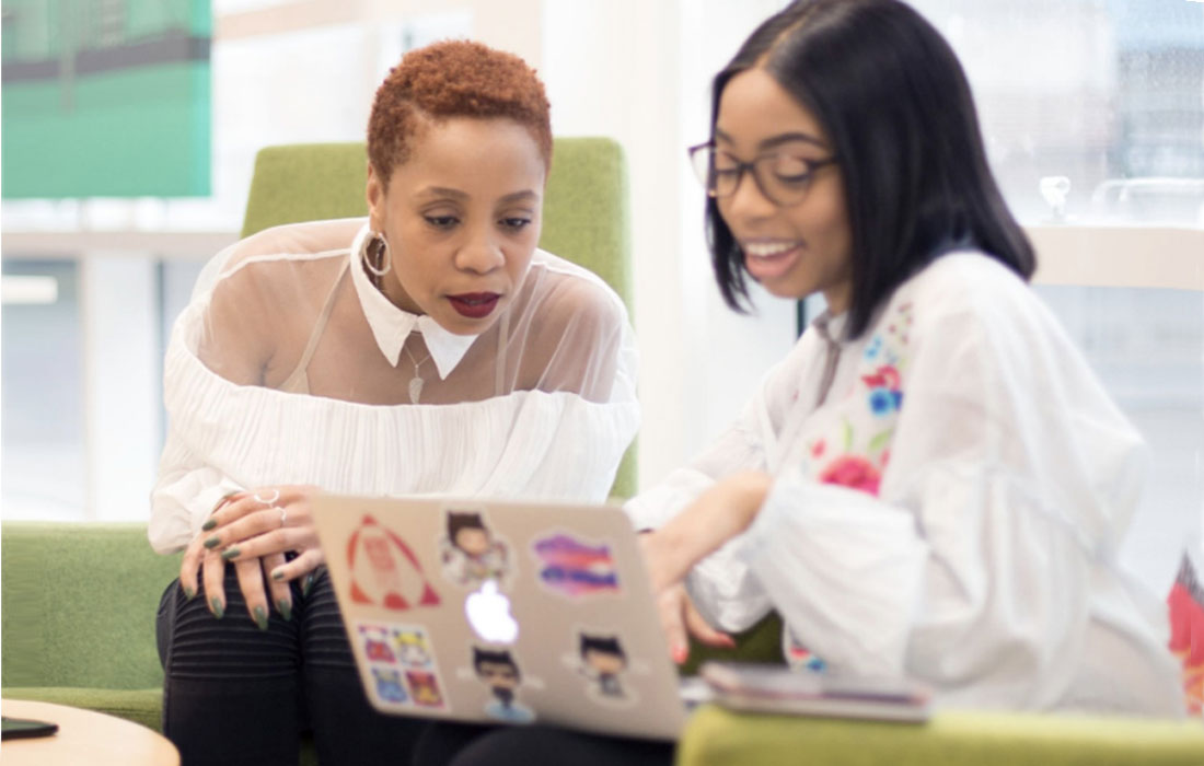 Photo of two women with a laptop