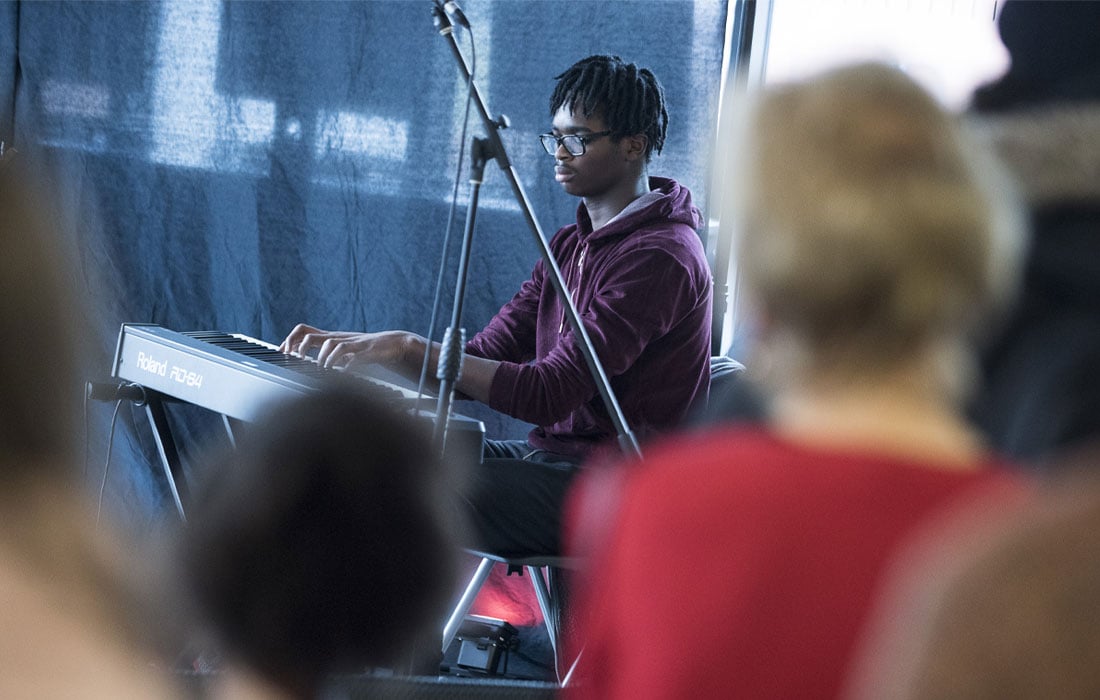 Photo of a young man playing a keyboard