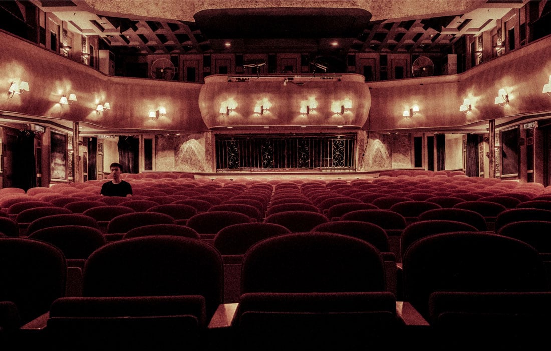 Photo of interior theatre with a single spectator