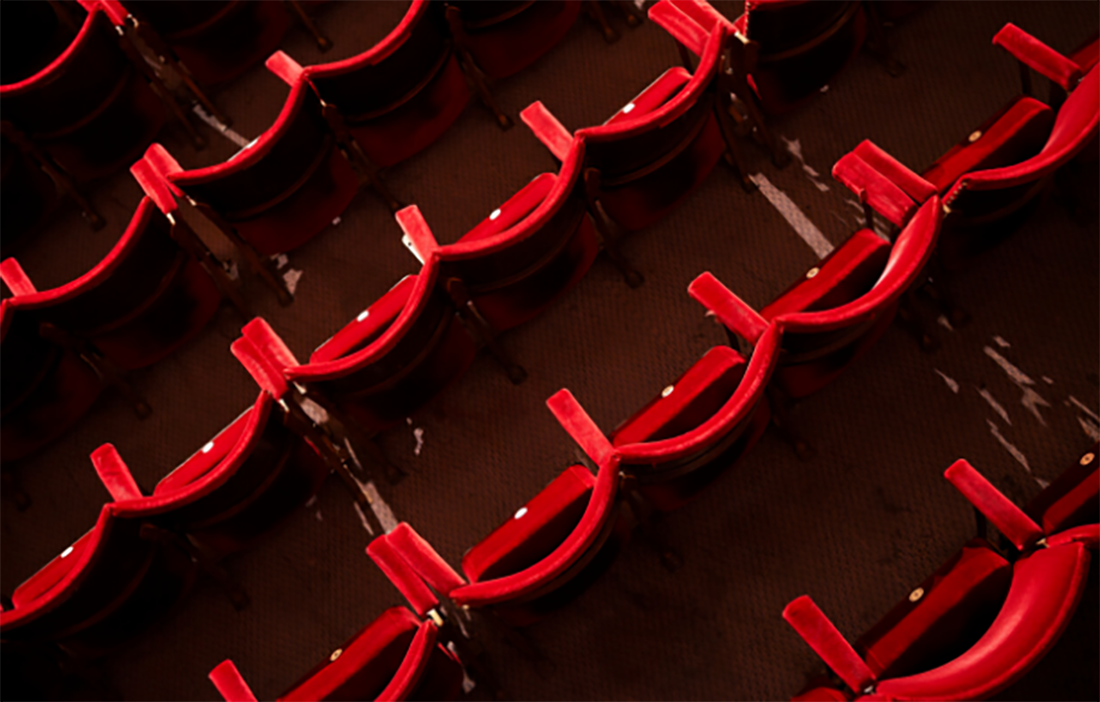 Bird's eye view of unoccupied red theatre seating