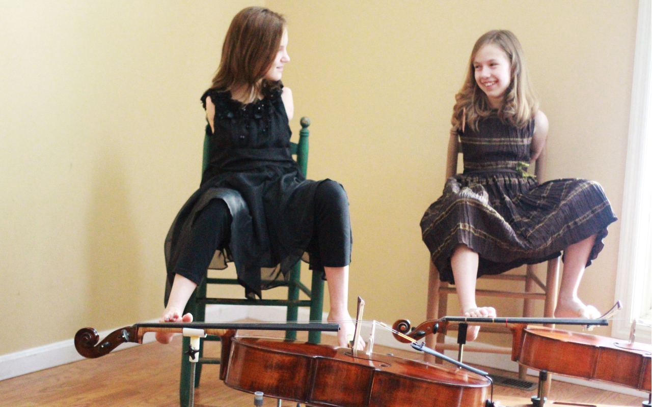 two girls playing the Cello