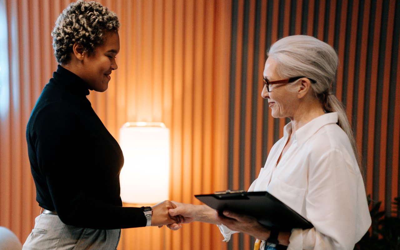 two women shaking hands