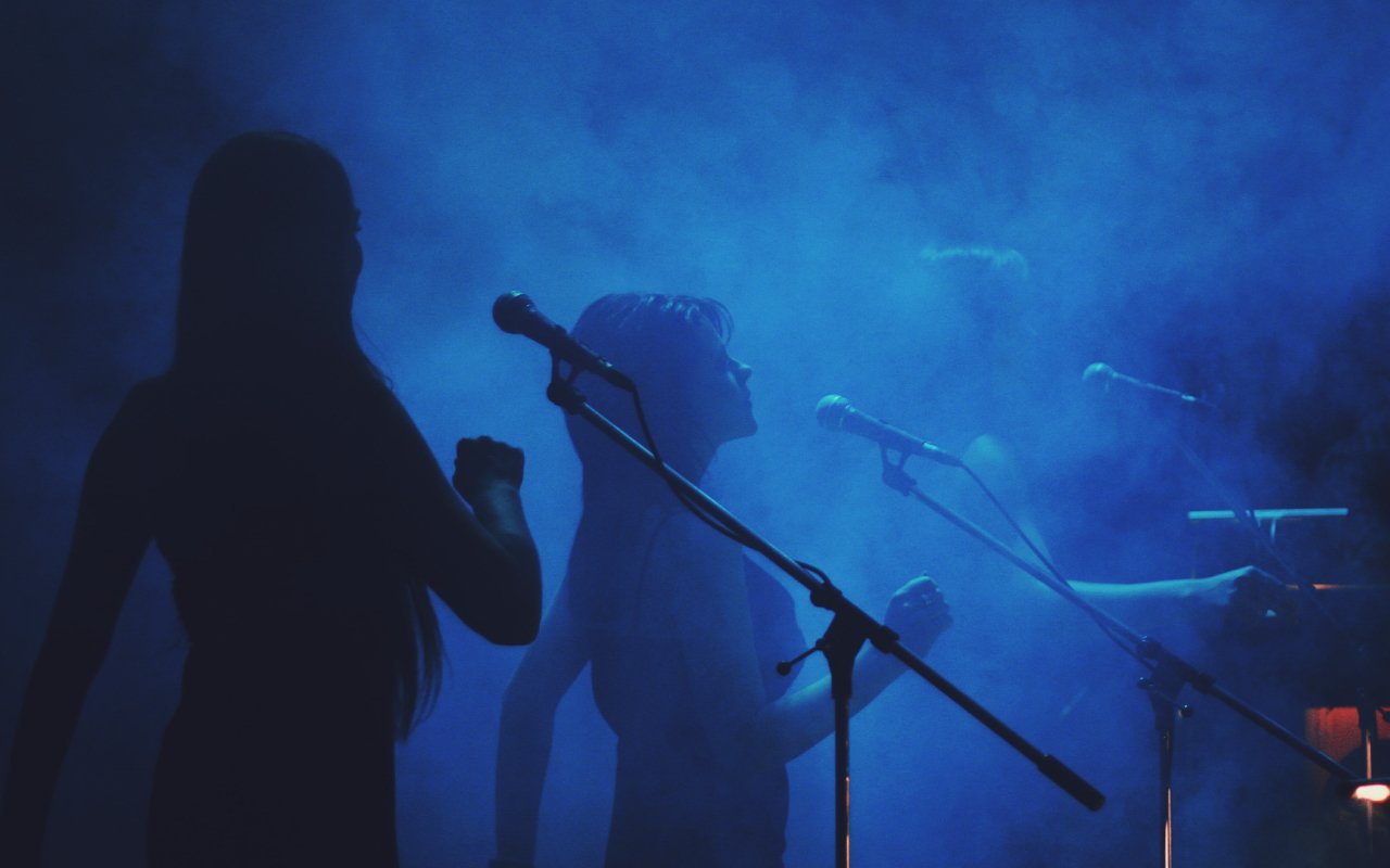 Three female musicians perform on stage