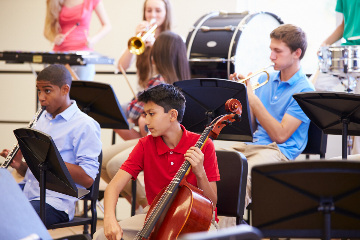 a group of children play musical instruments