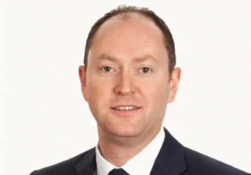 Mark Gregory, Interim Chair, Culture Derby. He is a white man with short brown hair and brown eyes. He is photographed against a white background wearing a suit.