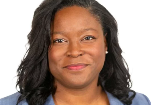 Headshot of Tonya Nelson, Executive Director, Enterprise and Innovation, Arts Council England. She is a Black woman with short, dark curly hair, photographed in front of a white backdrop. She wears a light blue blazer and pearl earrings.