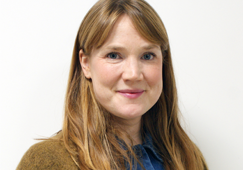 Moira Lascelles, UP Projects Executive Director & Head of Partnerships. She has mid-length, strawberry blonde hair, styled in bangs. She smiles at the camera. The background is white.