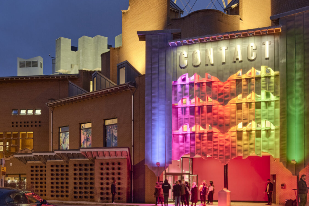 Exterior of Contact Theatre, Manchester lit up at night