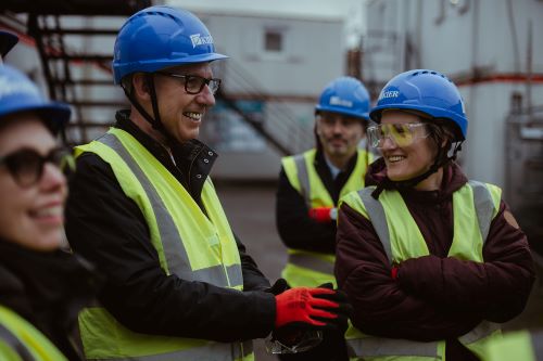 Image of Alex McGowan and others with hi-viz vests and helmet at Citizens Theatre redevelopment