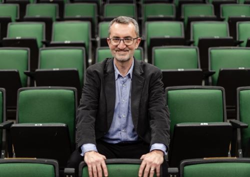 Eric Melear seated in an auditorium