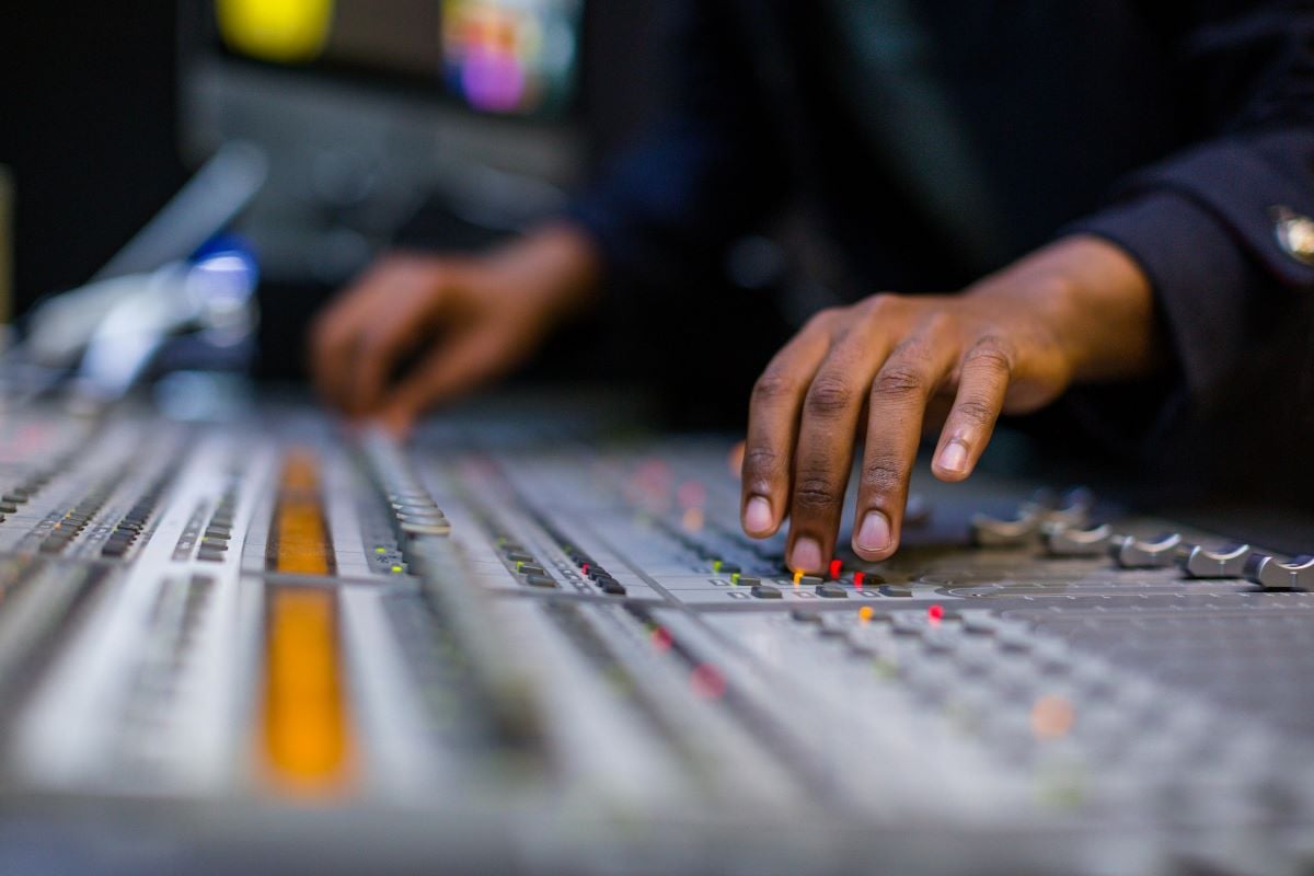 A person using a mixing desk