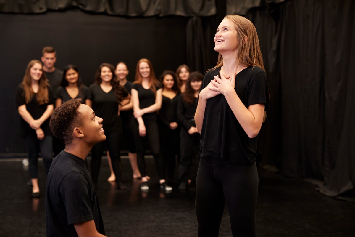 Male and female drama students at a performing arts school In studio improvisation class