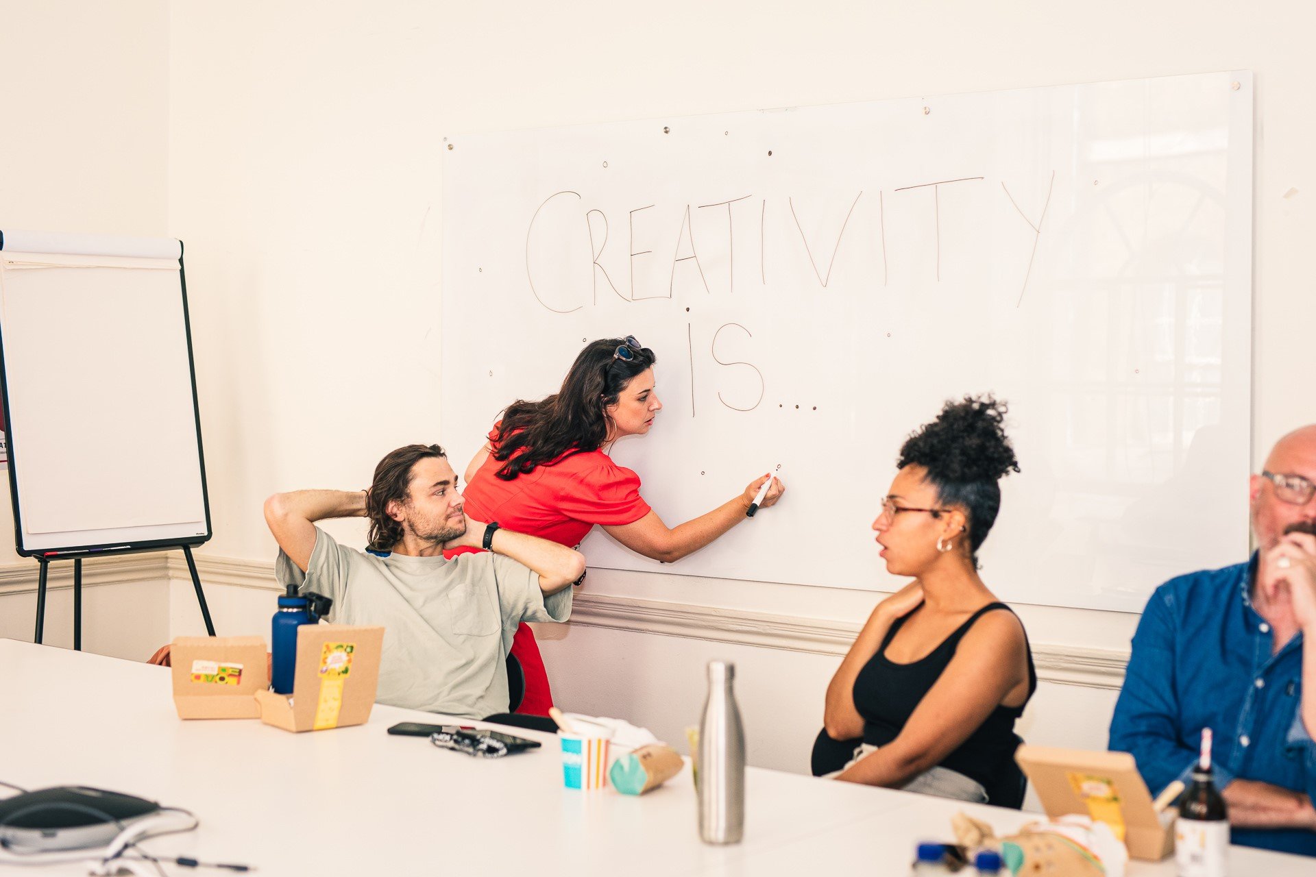 Workplace team exploring ideas on a whiteboard