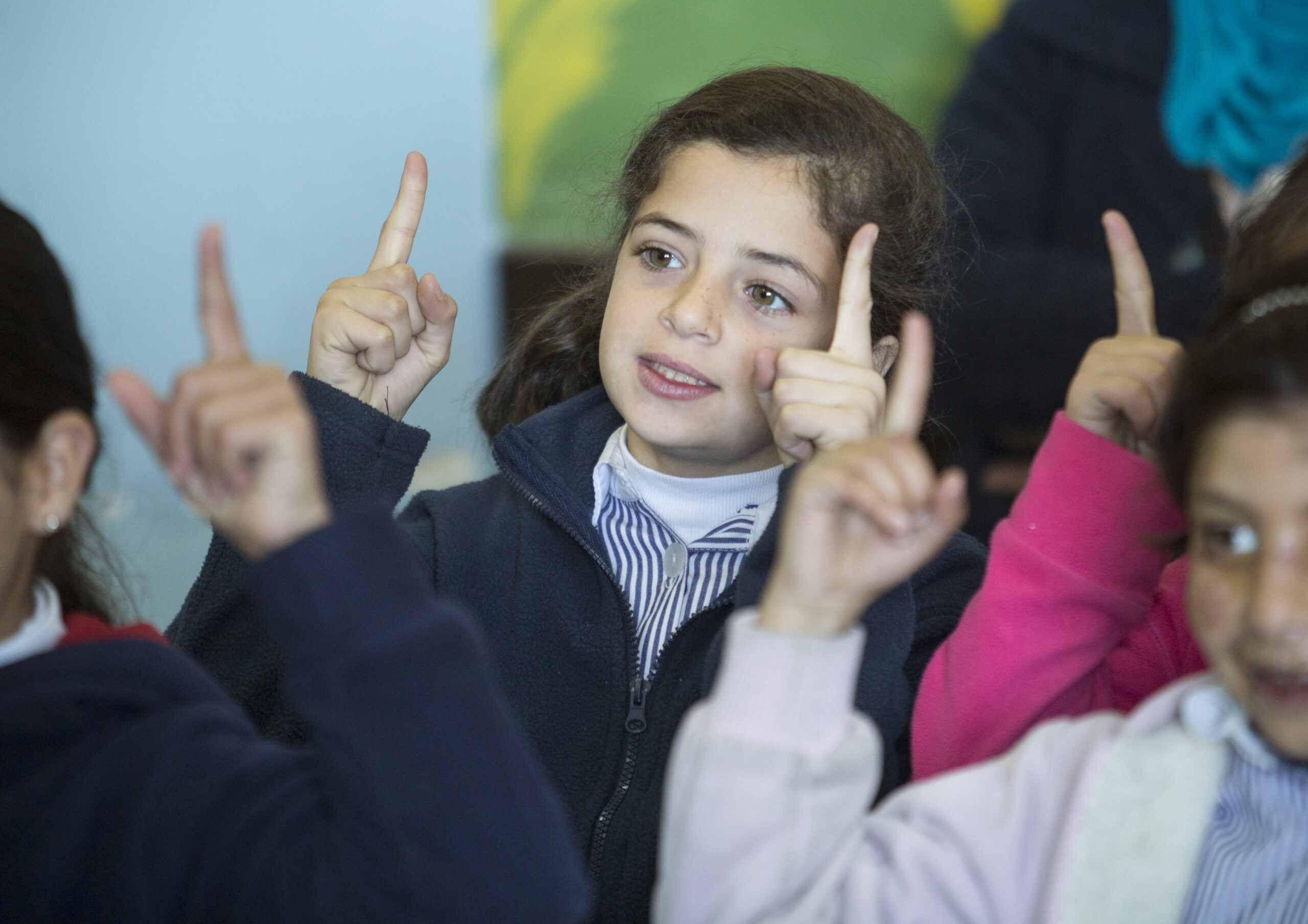 British Council World Voice Project Palestine, a group of girls pointing up